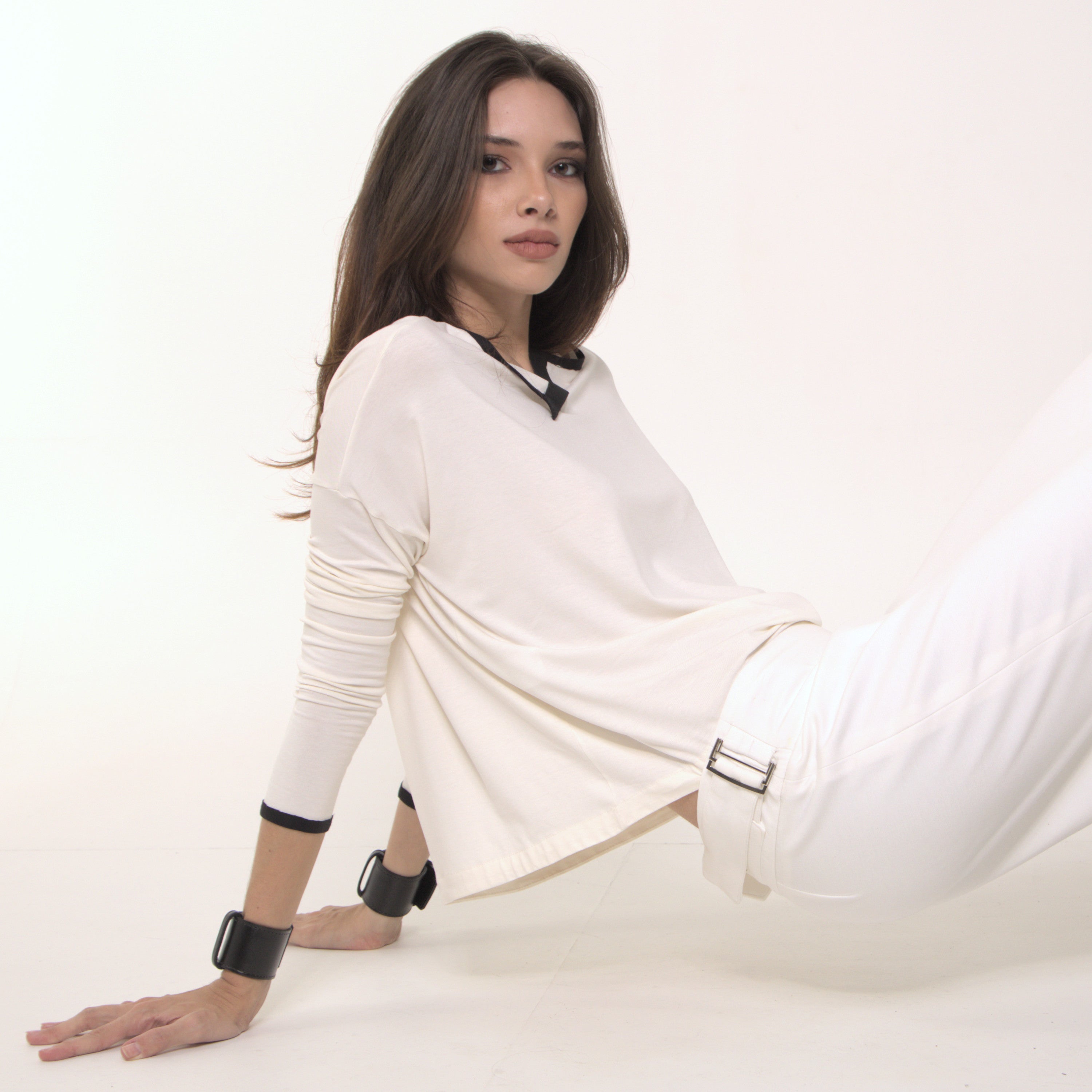 Arina - Blusa em malha manga comprida na cor off-white com debrum preto